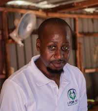 Josphat Mwema cooking in a children's home